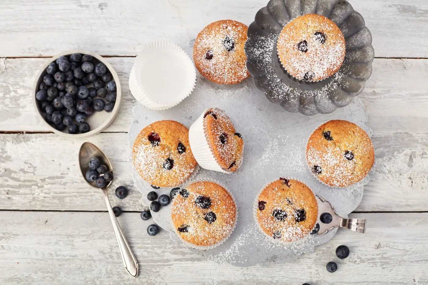 Picture - A few blueberry muffins laying on a table.