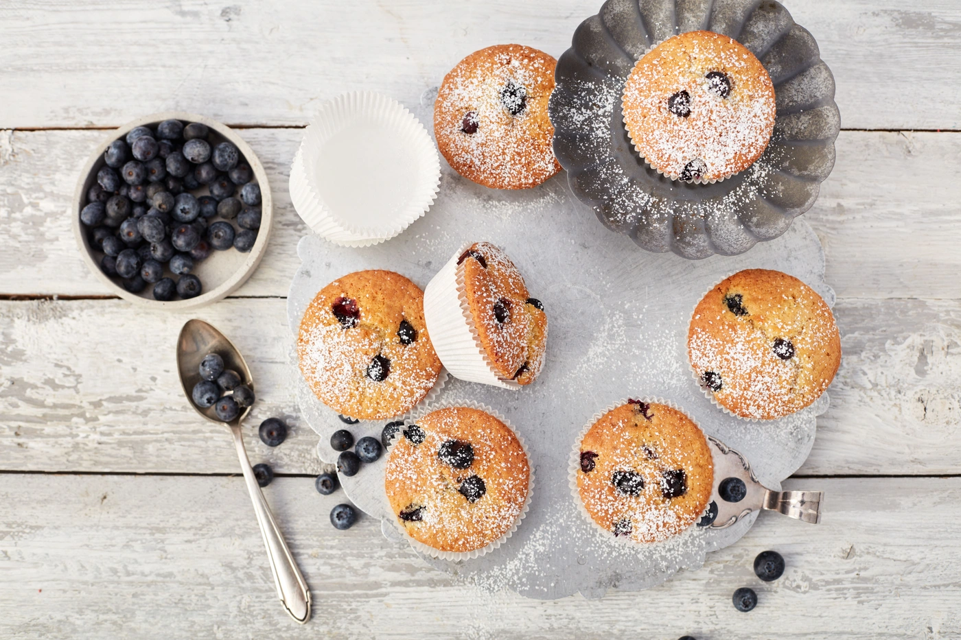 Picture - A few blueberry muffins laying on a table.